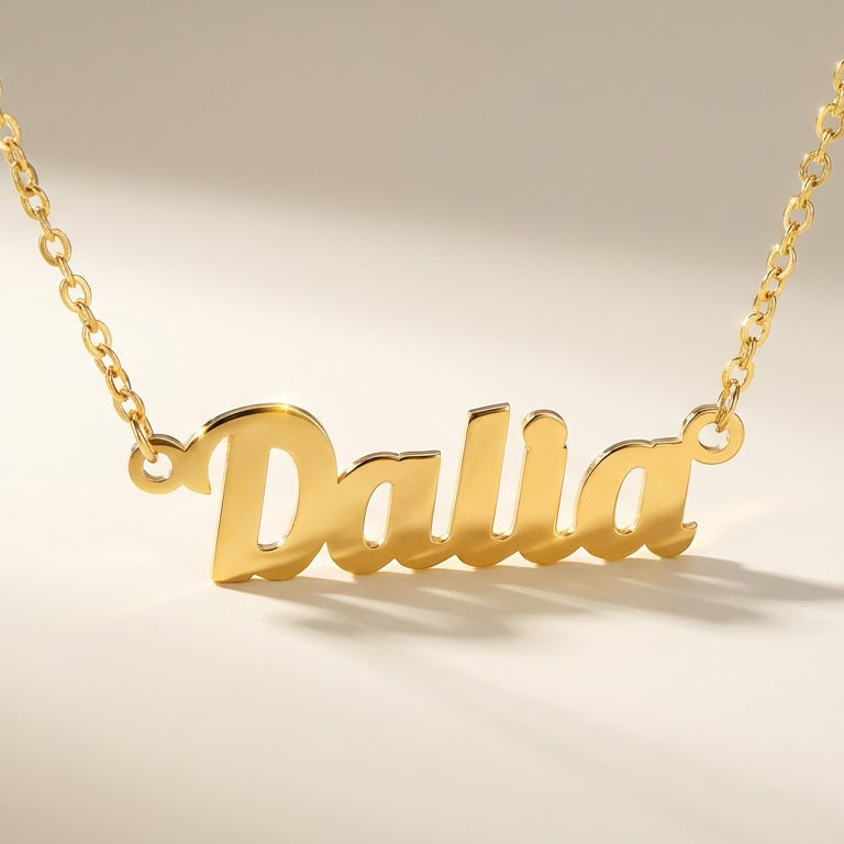 Gold necklace with name pendant on a beige background