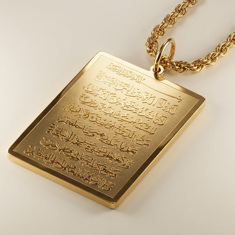 Gold pendant with engraved ayatul kursi on a light background