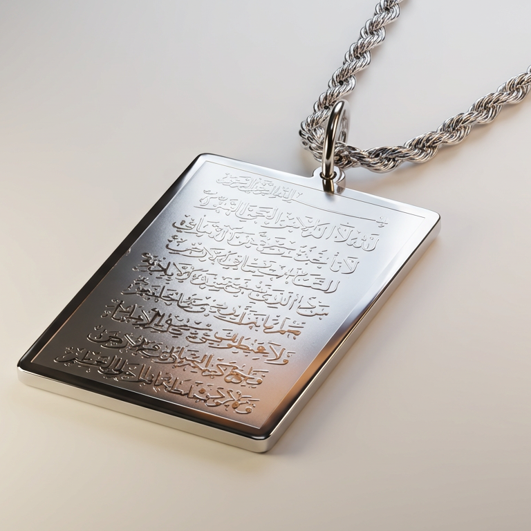 Silver pendant with engraved ayatul kursi on a beige background