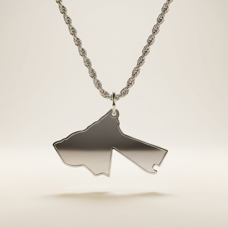 silver necklace with a pendant shaped like the country of Jordan on a light beige background