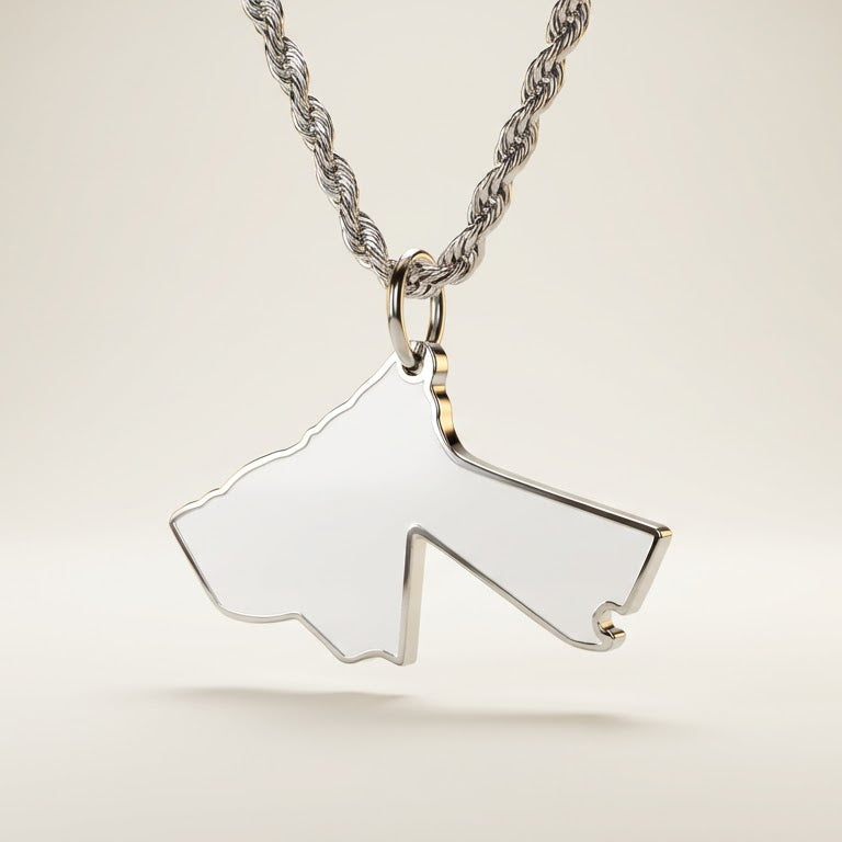 silver necklace with a pendant shaped like the country of Jordan on a light beige background
